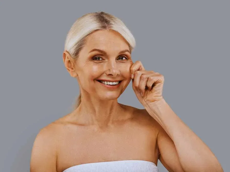 A woman pleased with her Kobido facial massage, with rejuvenated, firmer skin
