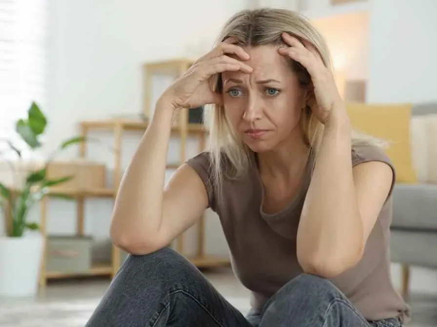 A woman psychologically affected by the ageing of her face. She needs a facial massage.